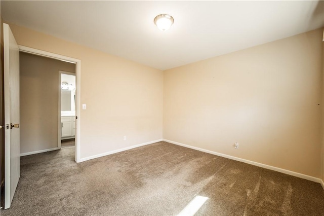 spare room with carpet flooring and baseboards