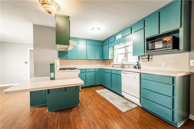 kitchen featuring range with gas cooktop, a peninsula, white dishwasher, black microwave, and a sink