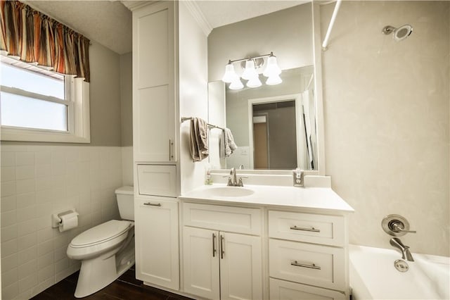 full bathroom featuring a wainscoted wall, tile walls, toilet, vanity, and wood finished floors