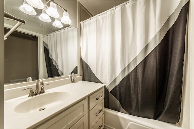 bathroom with shower / tub combo and vanity