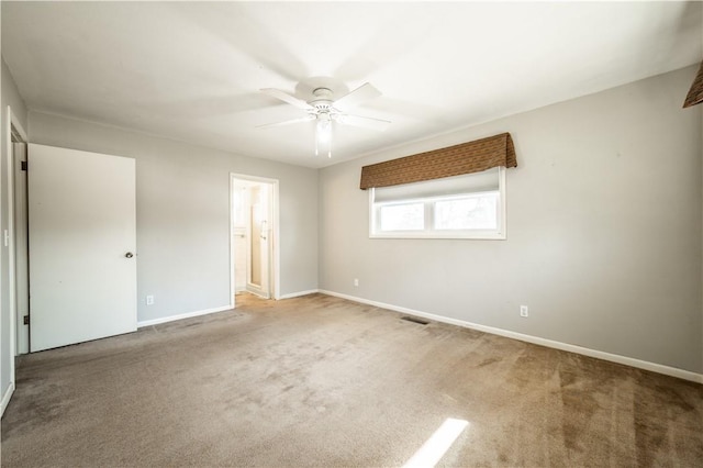 unfurnished bedroom featuring visible vents, baseboards, connected bathroom, ceiling fan, and carpet floors