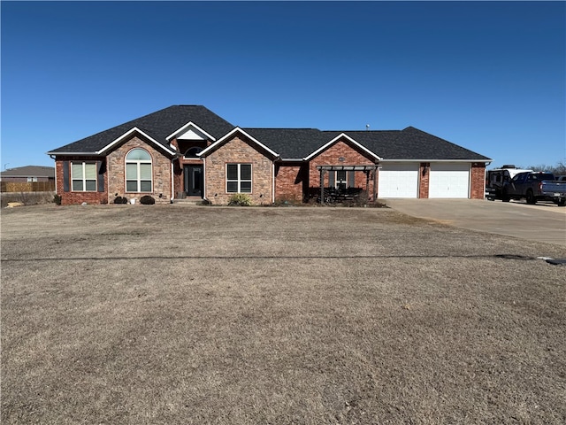 ranch-style house featuring an attached garage, brick siding, and driveway