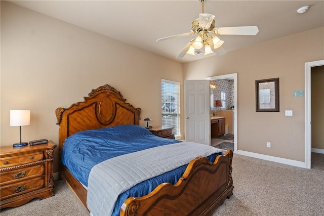 carpeted bedroom featuring ceiling fan, ensuite bath, and baseboards