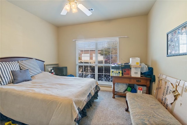 carpeted bedroom featuring visible vents and a ceiling fan