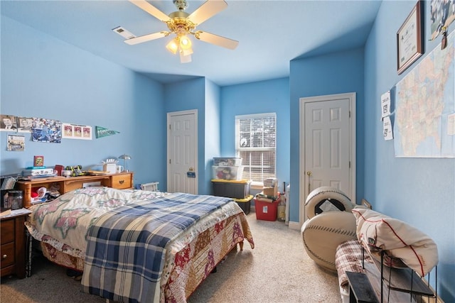 bedroom with baseboards, ceiling fan, visible vents, and carpet flooring