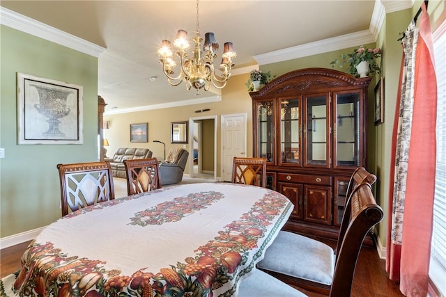 dining space with dark wood-type flooring, crown molding, baseboards, and an inviting chandelier