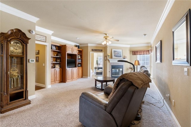 living room with a tile fireplace, baseboards, crown molding, and light colored carpet