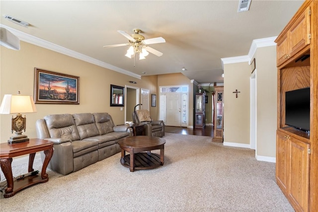 living area with light carpet, visible vents, and ornamental molding