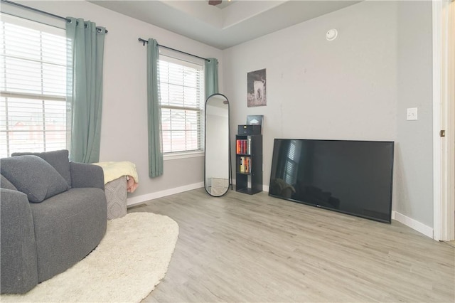 living room featuring baseboards and wood finished floors