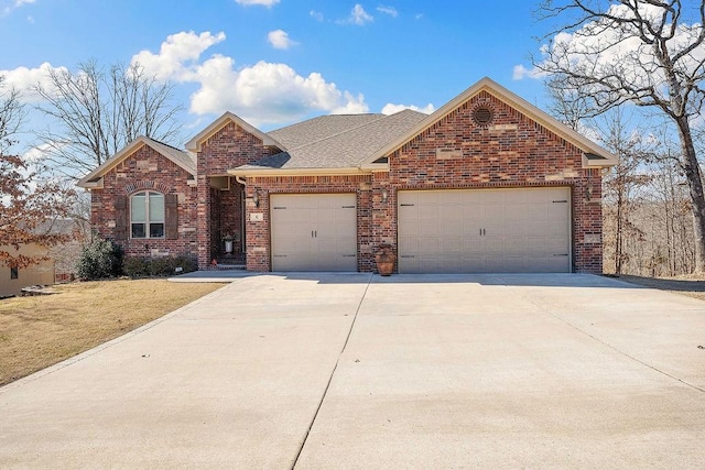 single story home featuring concrete driveway, an attached garage, brick siding, and a front lawn