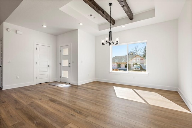 interior space featuring beam ceiling, baseboards, wood finished floors, and recessed lighting