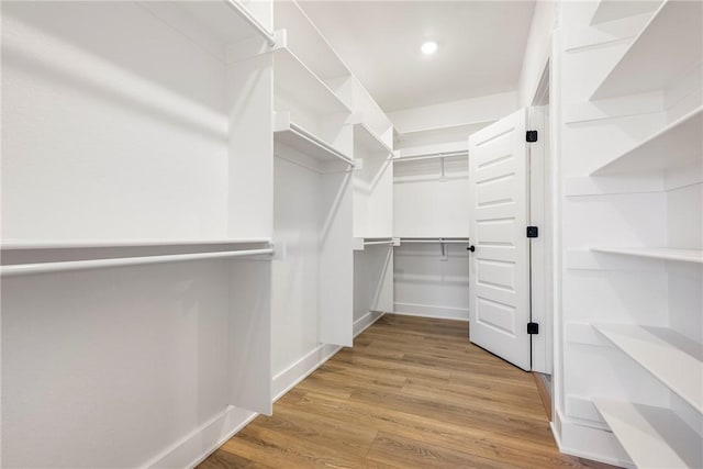 spacious closet with wood finished floors