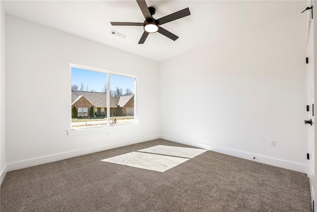 empty room featuring a ceiling fan, baseboards, visible vents, and carpet flooring