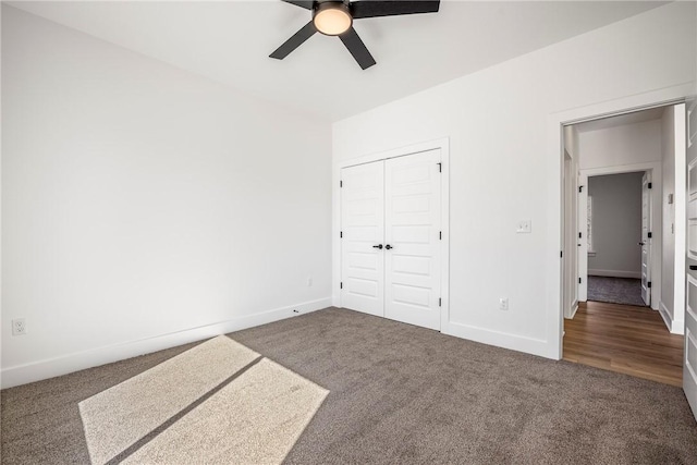 unfurnished bedroom featuring ceiling fan, a closet, baseboards, and carpet flooring