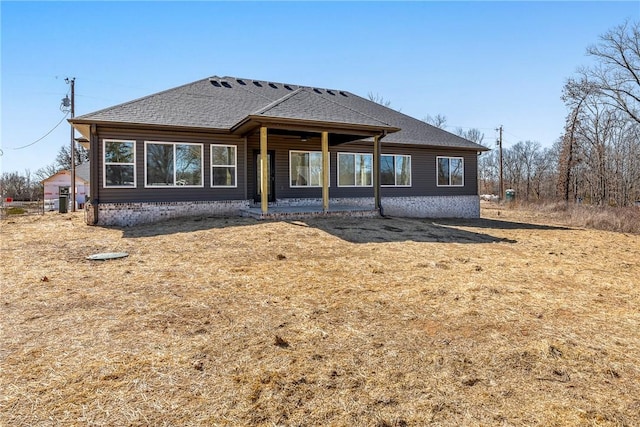 exterior space with roof with shingles