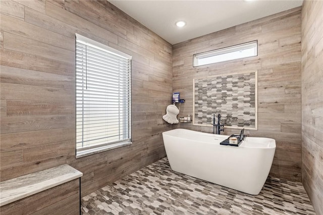 bathroom featuring recessed lighting and a freestanding tub