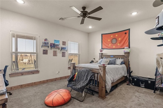 carpeted bedroom with a ceiling fan, recessed lighting, visible vents, and baseboards