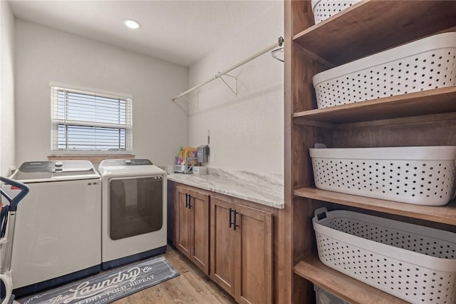 washroom with light wood-type flooring, laundry area, washer and clothes dryer, and recessed lighting