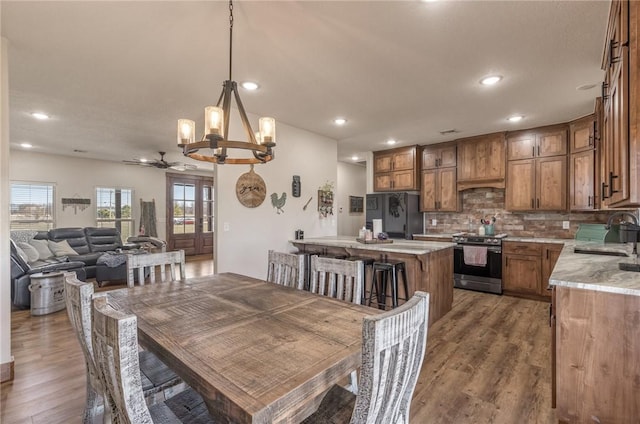 dining area featuring french doors, light wood-type flooring, and recessed lighting