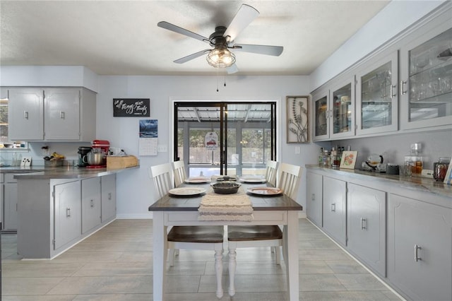 dining area featuring ceiling fan and baseboards