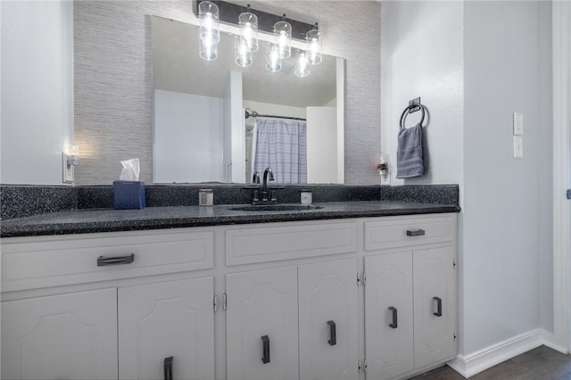 full bathroom with baseboards and vanity