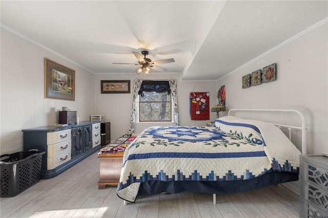 bedroom featuring crown molding, a ceiling fan, and wood tiled floor