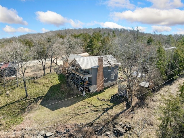 bird's eye view with a wooded view