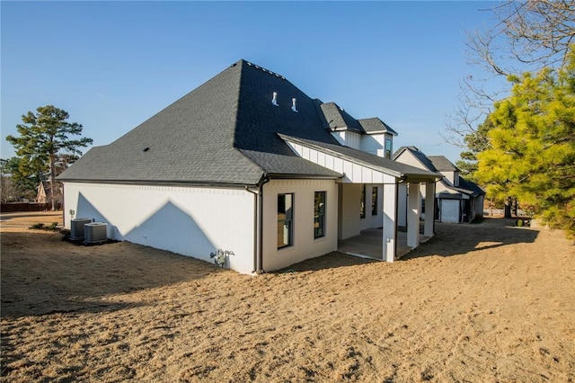 view of side of property with roof with shingles and cooling unit