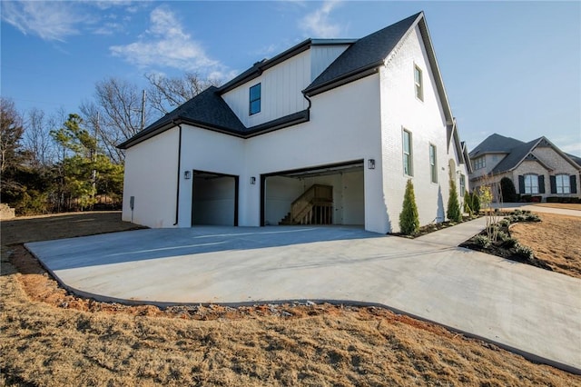 view of property exterior with concrete driveway and an attached garage