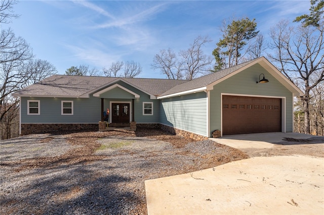 ranch-style house featuring a garage, roof with shingles, and driveway