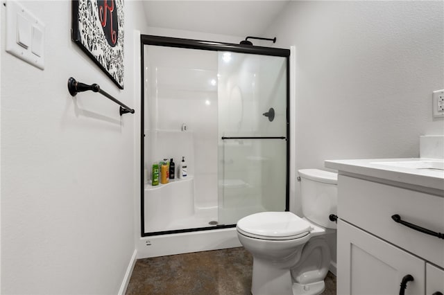 bathroom with toilet, a shower stall, baseboards, and vanity