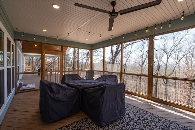 sunroom with plenty of natural light and a ceiling fan