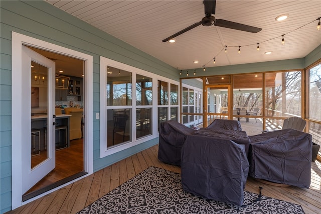 sunroom / solarium featuring ceiling fan and wooden ceiling