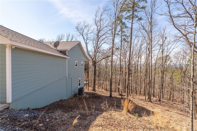 view of side of home with central air condition unit