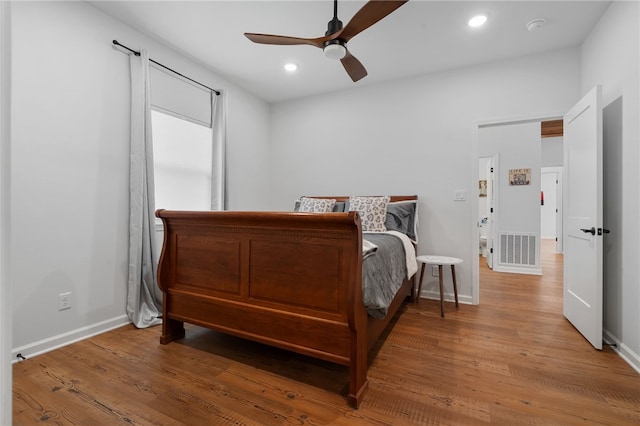 bedroom featuring recessed lighting, visible vents, baseboards, and wood finished floors