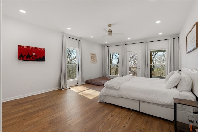 bedroom with multiple windows, wood finished floors, and recessed lighting