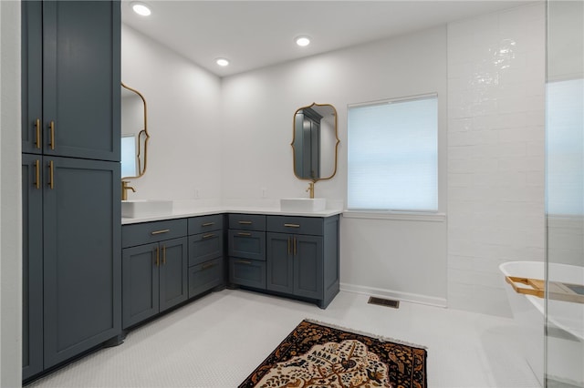 bathroom featuring double vanity, a sink, visible vents, and recessed lighting