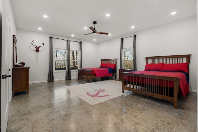 bedroom with concrete flooring, multiple windows, baseboards, and recessed lighting