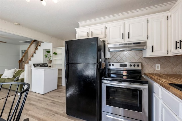 kitchen featuring washer / dryer, freestanding refrigerator, stainless steel range with electric cooktop, light wood-type flooring, and under cabinet range hood