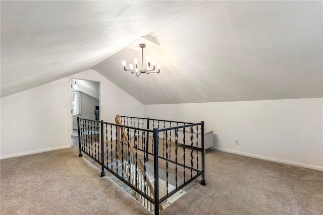 bonus room featuring carpet flooring, vaulted ceiling, baseboards, and an inviting chandelier