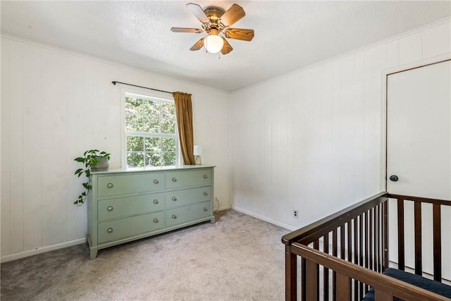 unfurnished bedroom featuring a ceiling fan, a nursery area, and light carpet