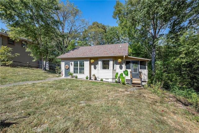 ranch-style home with crawl space, a sunroom, and a front lawn