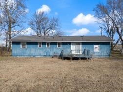 rear view of property with a wooden deck