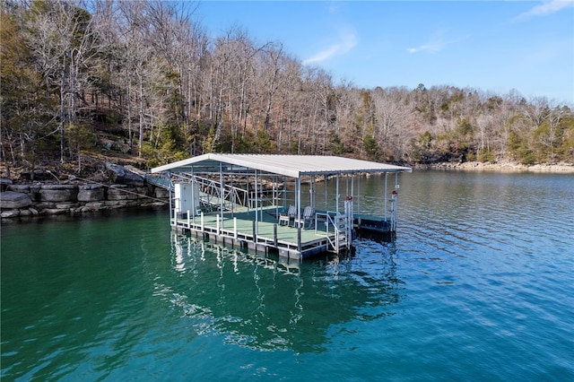 dock area with a water view and a forest view