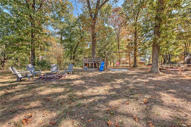 view of yard with a fire pit and a playground