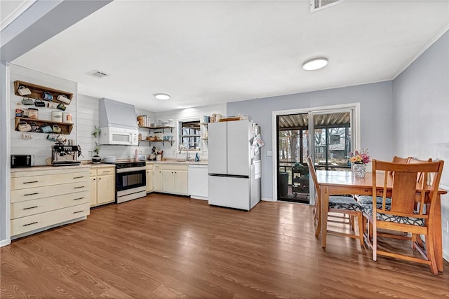 kitchen with white appliances, visible vents, dark wood-type flooring, light countertops, and open shelves