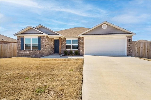 ranch-style home featuring driveway, an attached garage, fence, a front yard, and brick siding