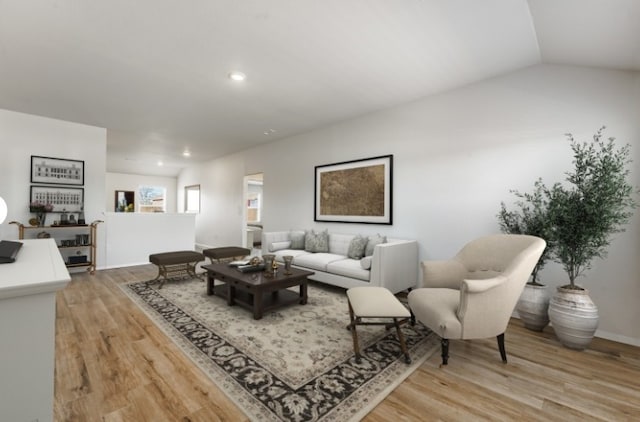 living room featuring lofted ceiling, recessed lighting, and light wood-style floors