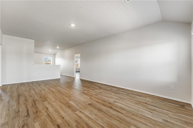 spare room with light wood-type flooring, baseboards, and recessed lighting