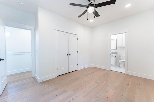 unfurnished bedroom with light wood finished floors, baseboards, connected bathroom, and recessed lighting